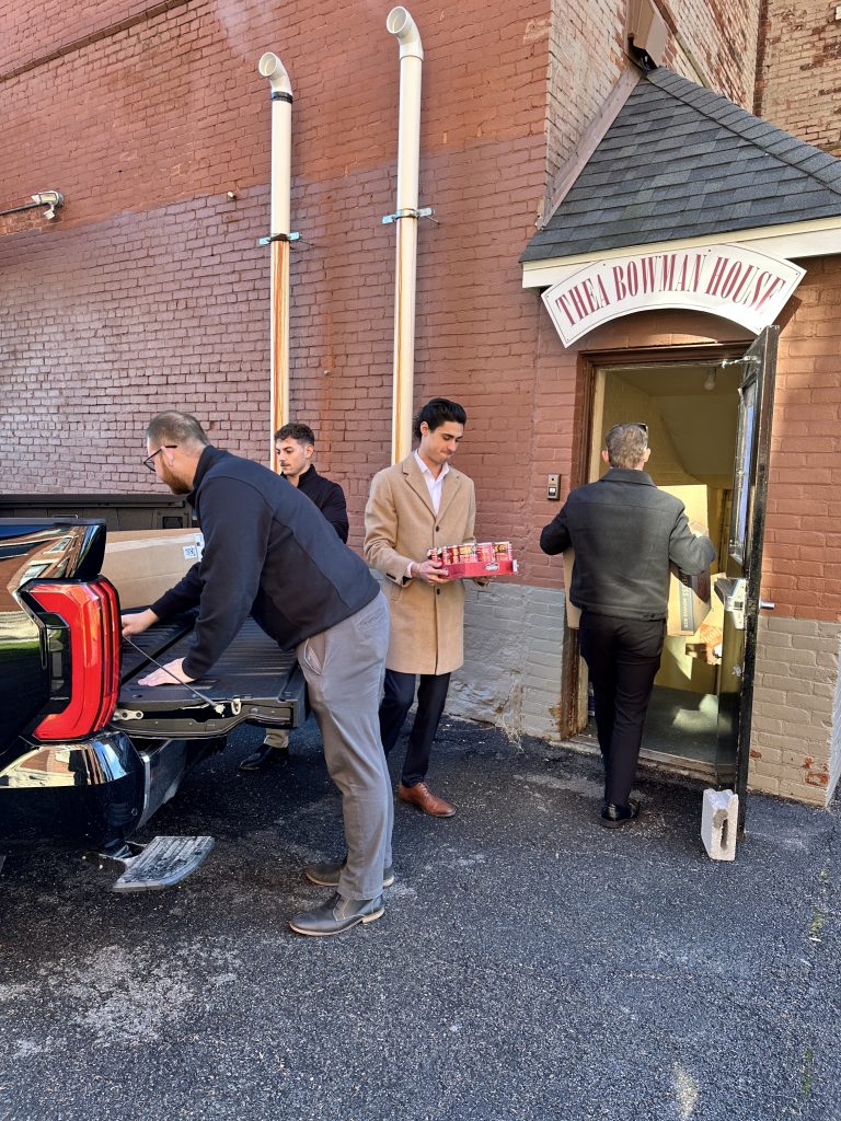 Steet Ponte Auto Group employees helping load food donations into the Thea Bowman House Food Pantry in Utica, NY