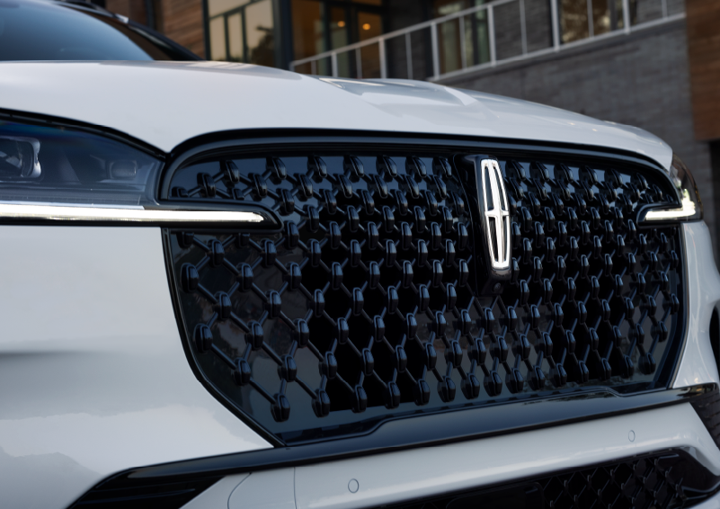 The black grille of a white 2025 Lincoln Aviator® SUV is shown with its fog lights on. | Steet-Ponte Lincoln in Yorkville NY