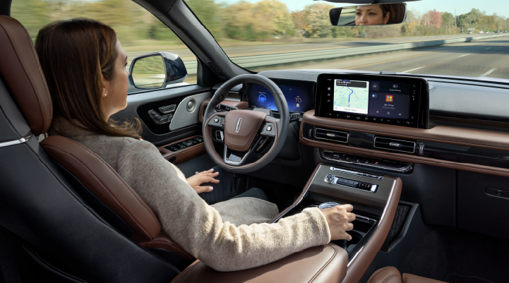 A woman is seen sitting in the driver’s seat of her 2025 Lincoln Aviator® SUV with her hands off the steering wheel. | Steet-Ponte Lincoln in Yorkville NY
