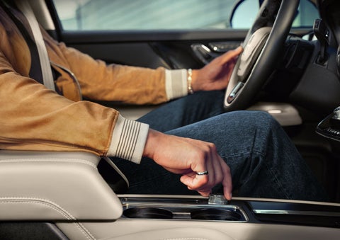 The driver of a 2024 Lincoln Corsair® SUV is shown selecting the drive mode. | Steet-Ponte Lincoln in Yorkville NY