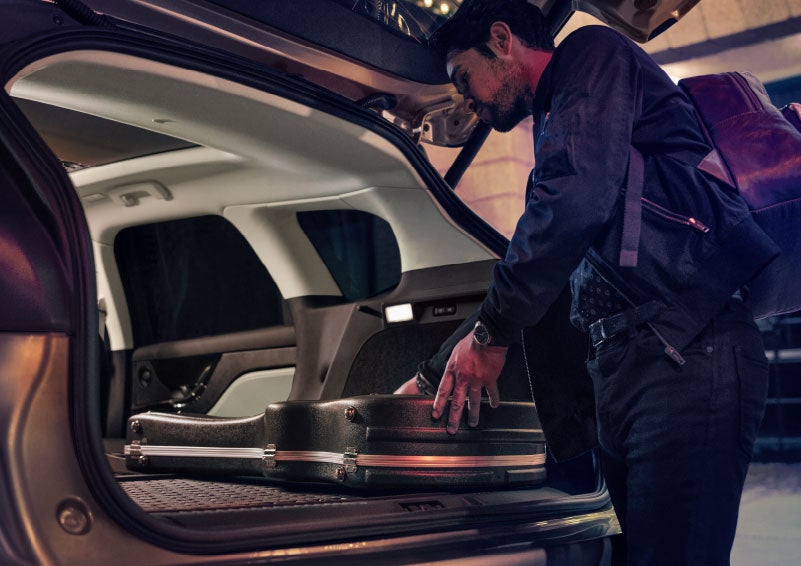 A man is shown loading cargo into the rear of a 2024 Lincoln Corsair® SUV with the second-row seats folded flat. | Steet-Ponte Lincoln in Yorkville NY