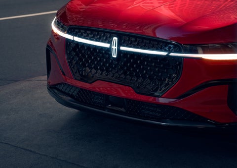 The available front LED light bar and center Lincoln Star logo glow at dusk. | Steet-Ponte Lincoln in Yorkville NY