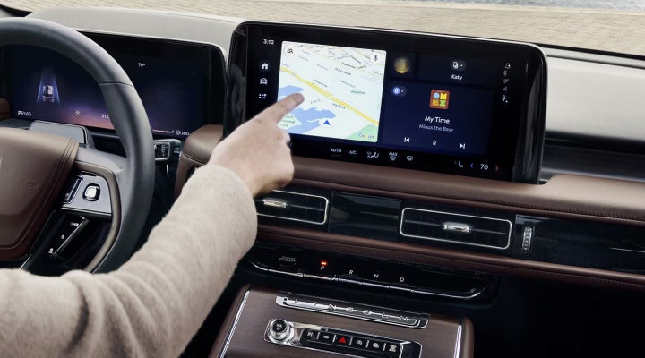 A person is tapping the center display touchscreen of a 2026 Lincoln Aviator® SUV. | Steet-Ponte Lincoln in Yorkville NY