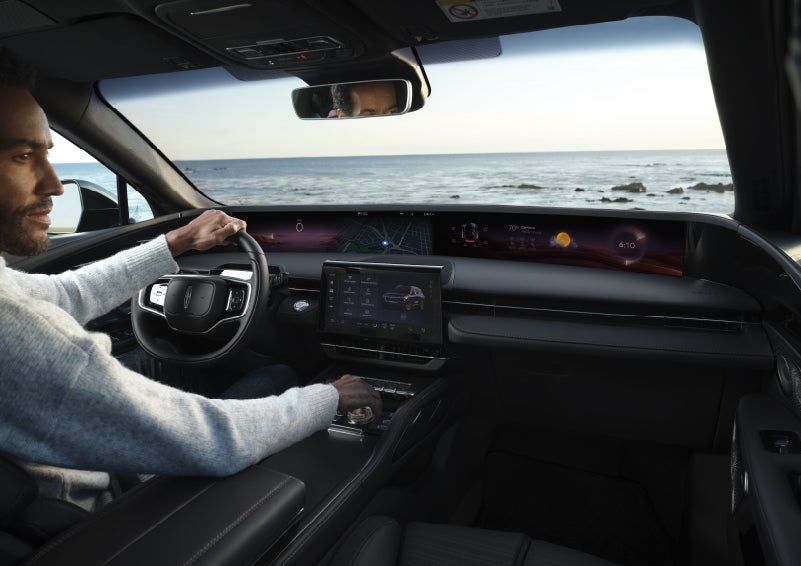 A driver of a parked 2026 Lincoln Nautilus® SUV takes a relaxing moment at a seaside overlook while inside his Nautilus. | Steet-Ponte Lincoln in Yorkville NY