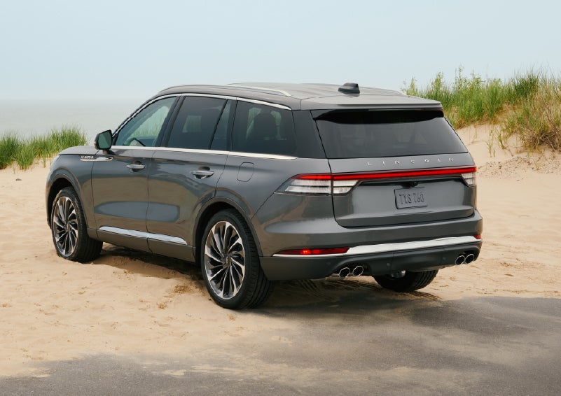 A 2027 Lincoln Aviator® SUV is parked next to sand dunes. | Steet-Ponte Lincoln in Yorkville NY