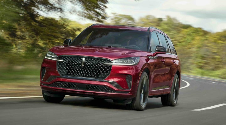 A 2027 Lincoln Aviator® SUV is being driven on a country road | Steet-Ponte Lincoln in Yorkville NY