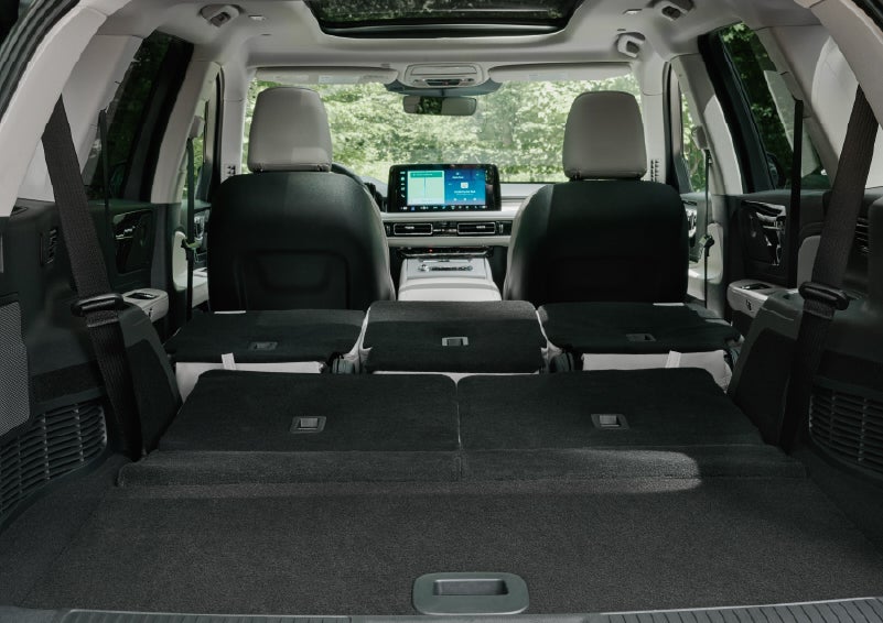 A rear to front view of the interior of a 2027 Lincoln Aviator® Black Label™ SUV shows the third and second rows folded flat | Steet-Ponte Lincoln in Yorkville NY
