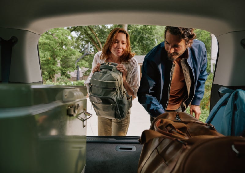 A couple loads luggage into the rear of a 2027 Lincoln Aviator® Black Label™ SUV..e 202 | Steet-Ponte Lincoln in Yorkville NY