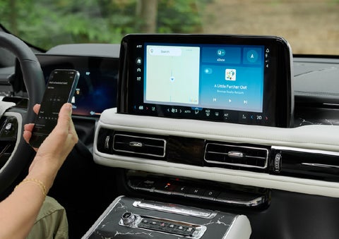 A person pairs thier phone with the center touchscreen of a 2027 Lincoln Aviator® Black Label™ SUV | Steet-Ponte Lincoln in Yorkville NY
