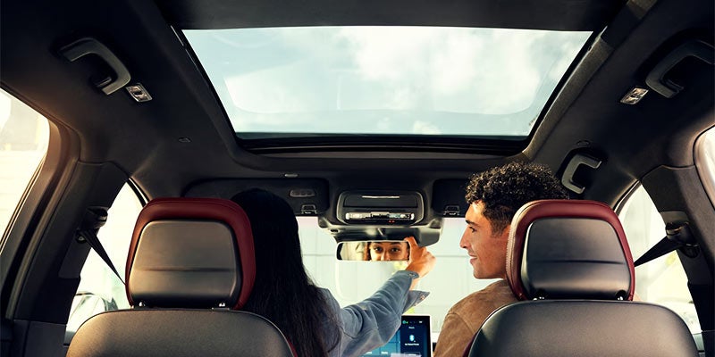 Man adjusting mirror in a new Lincoln Corsair in Yorkville, NY