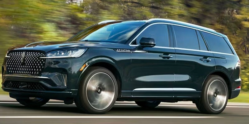 side view of a 2025 Lincoln Aviator driving down a road