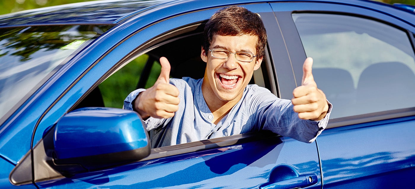 man giving thumbs up from car